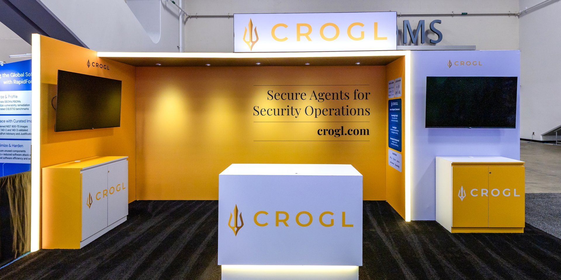 Crogl booth at RSAC 2026 in trident orange and white, with a lit header sign, a serif tagline wall reading Secure Agents for Security Operations, and branded counters